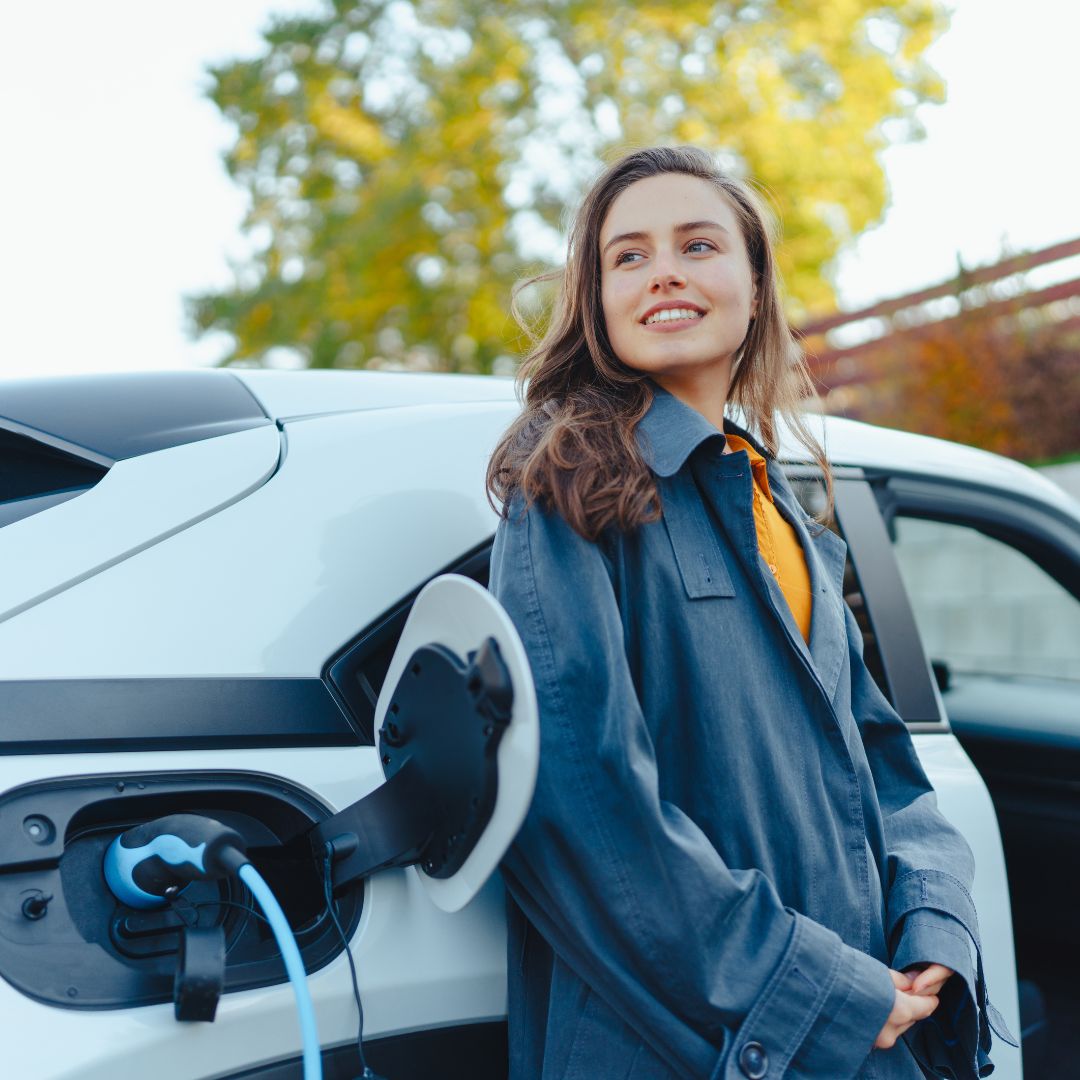 Woman waiting while electric vehicle charges